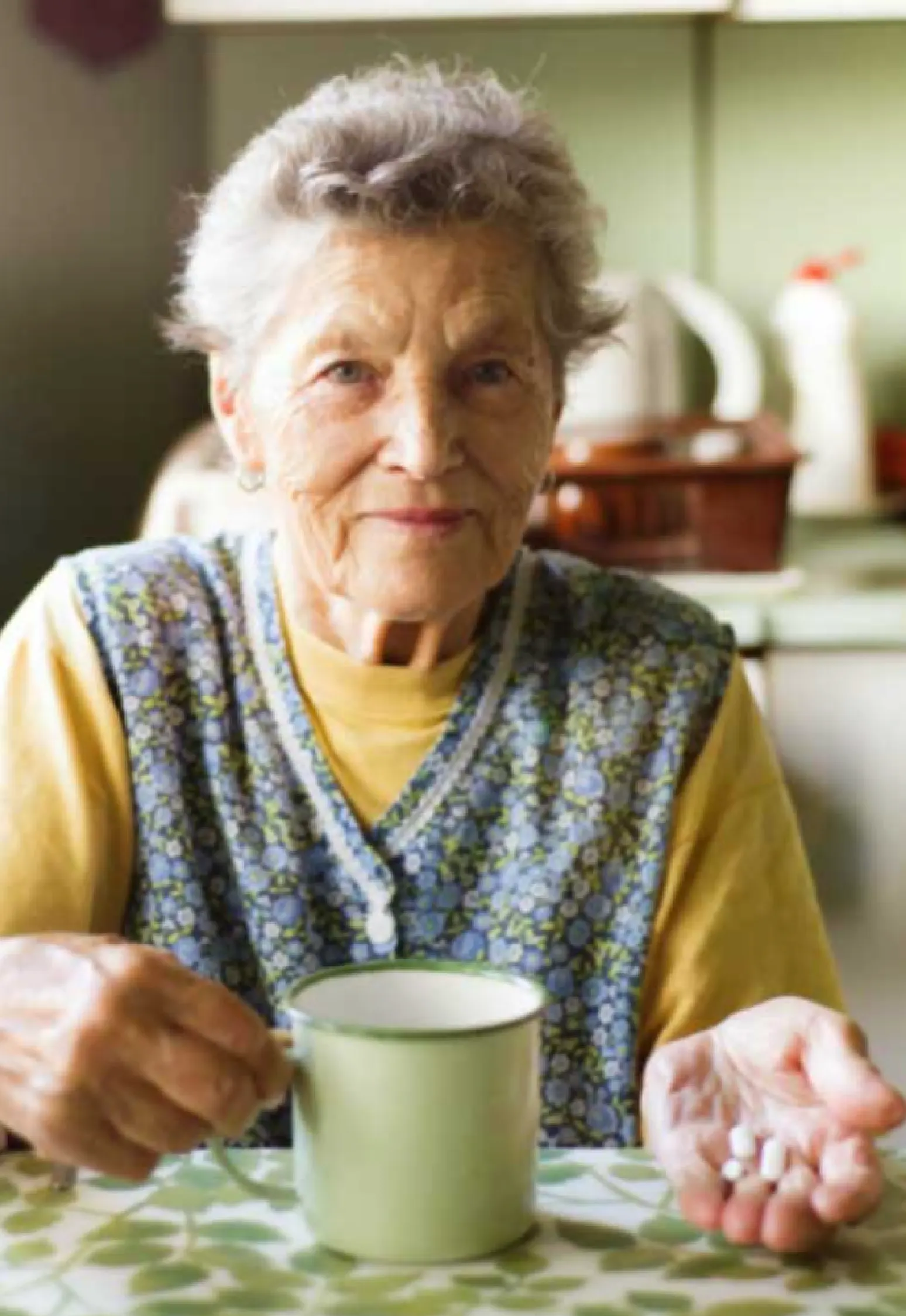 Senior woman at kitchen table talking medication Senior woman at kitchen table talking medication