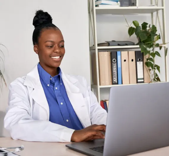 Young African-American female doctor working at computer Young African-American female doctor working at computer