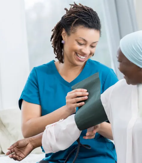 African-American nurse checking the blood pressure of a senior African-American woman at a clinic African-American nurse checking the blood pressure of a senior African-American woman at a clinic