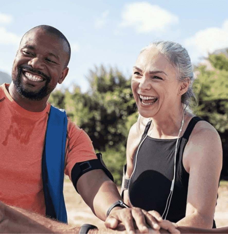 Senior man and woman laughing and playing sports outside